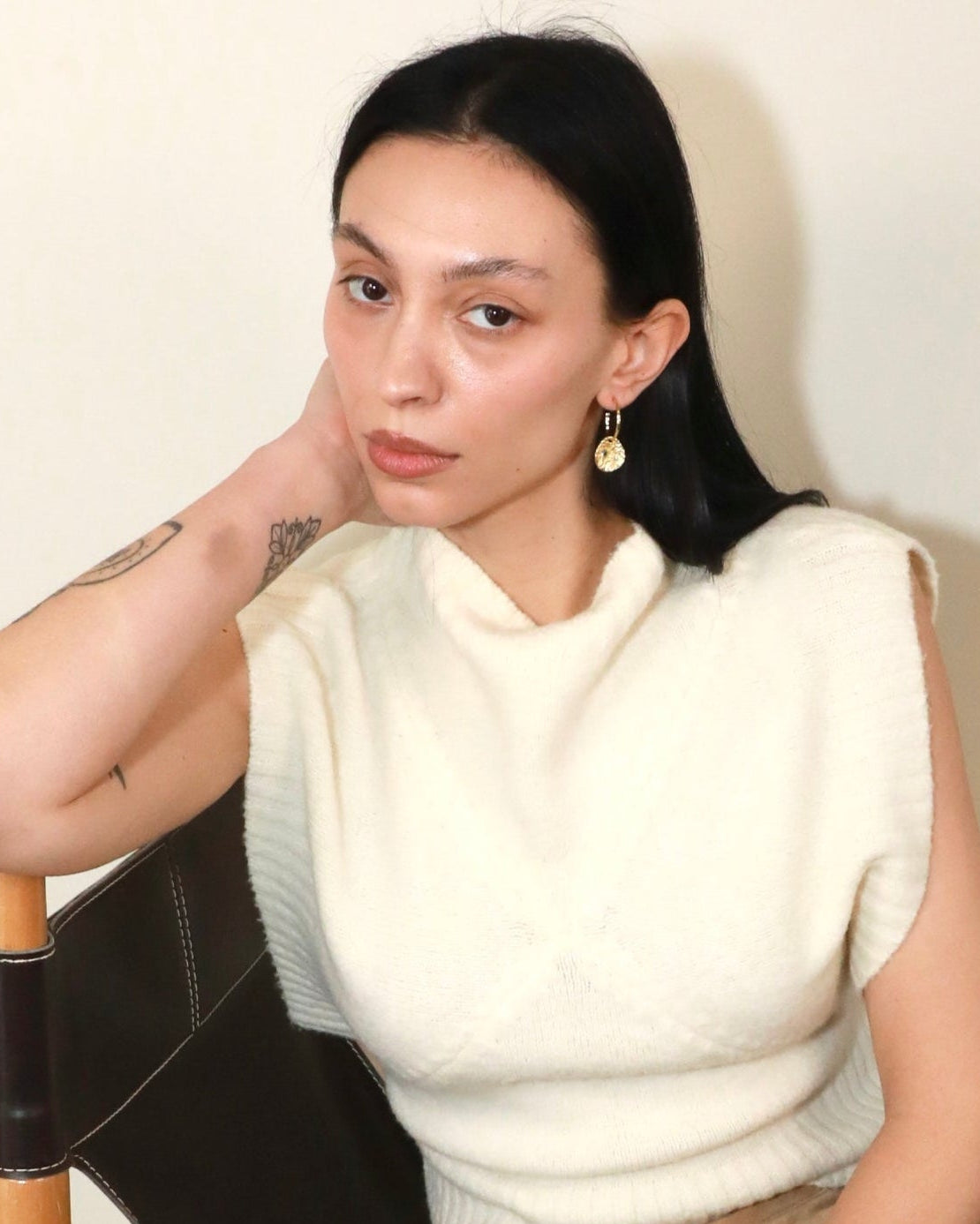 Gold coin drop earrings with hammered 18K gold-plated brass pendants and two round lab-grown aquamarine-blue spinel stones model