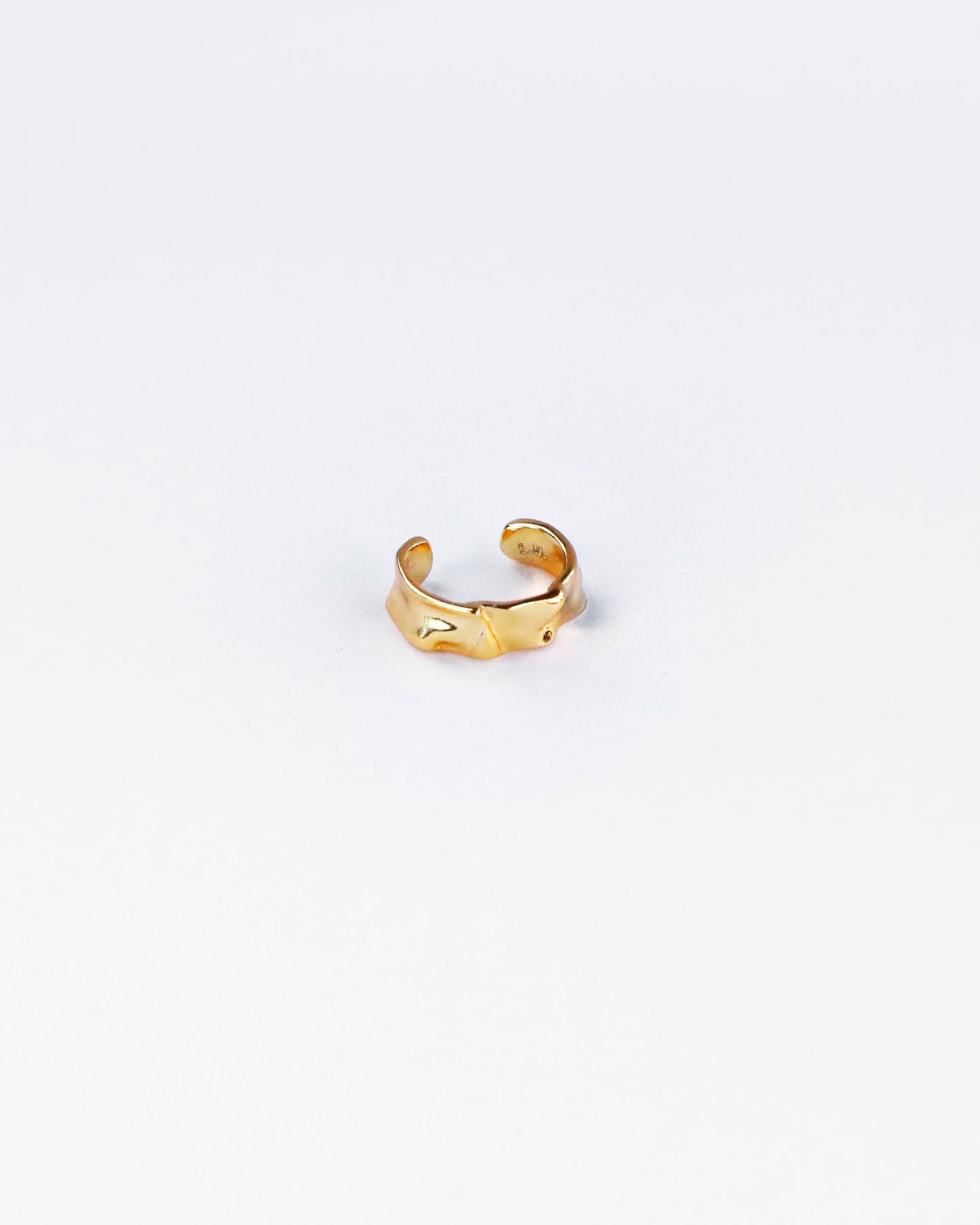 18K gold plated sterling silver ear cuff on white background, showcasing wavy textured surface