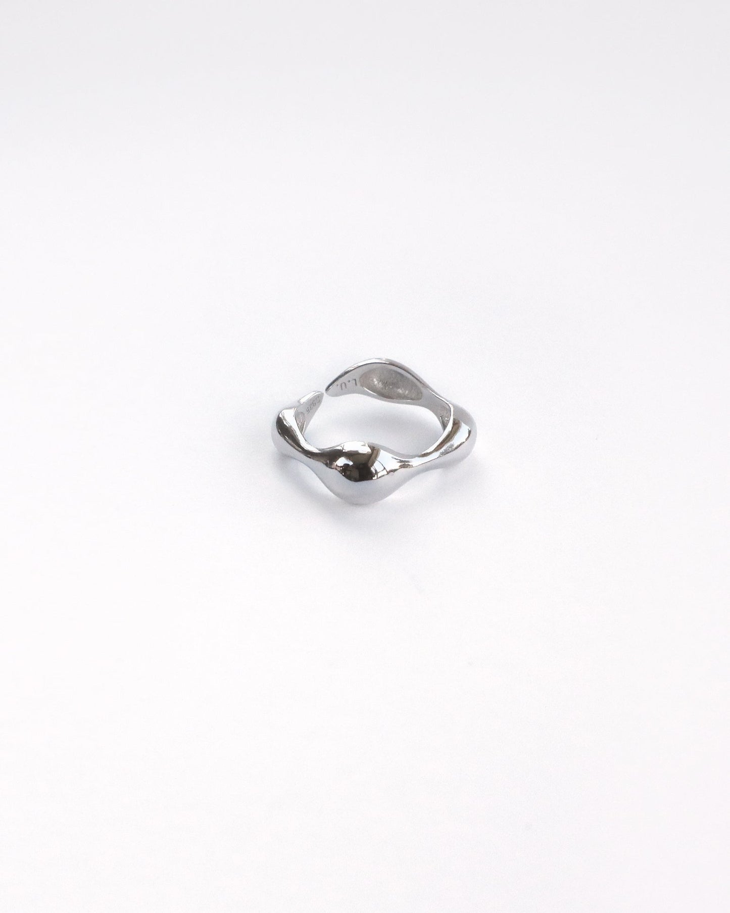 Close-up of polished sterling silver ring with sculptural organic shape – thick version