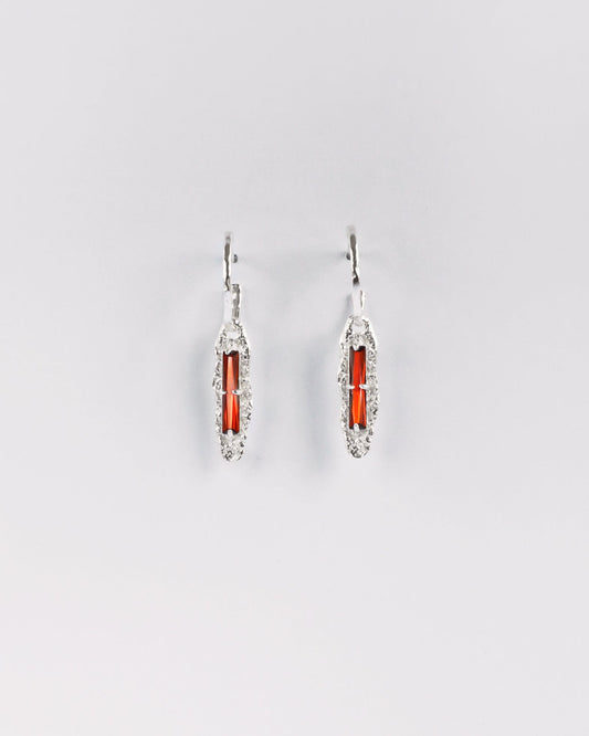 Sterling silver earrings with red cubic zirconia on white background