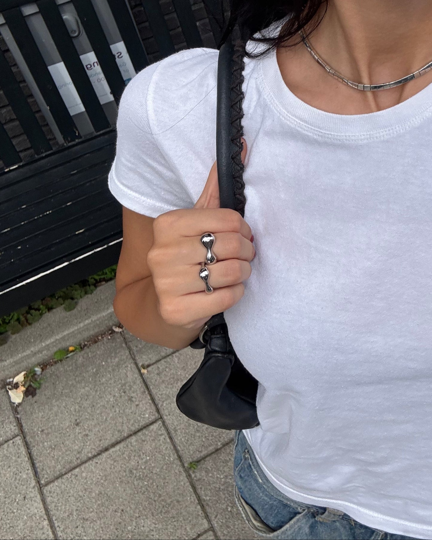 Street style outfit with white tee and stacked organic silver rings