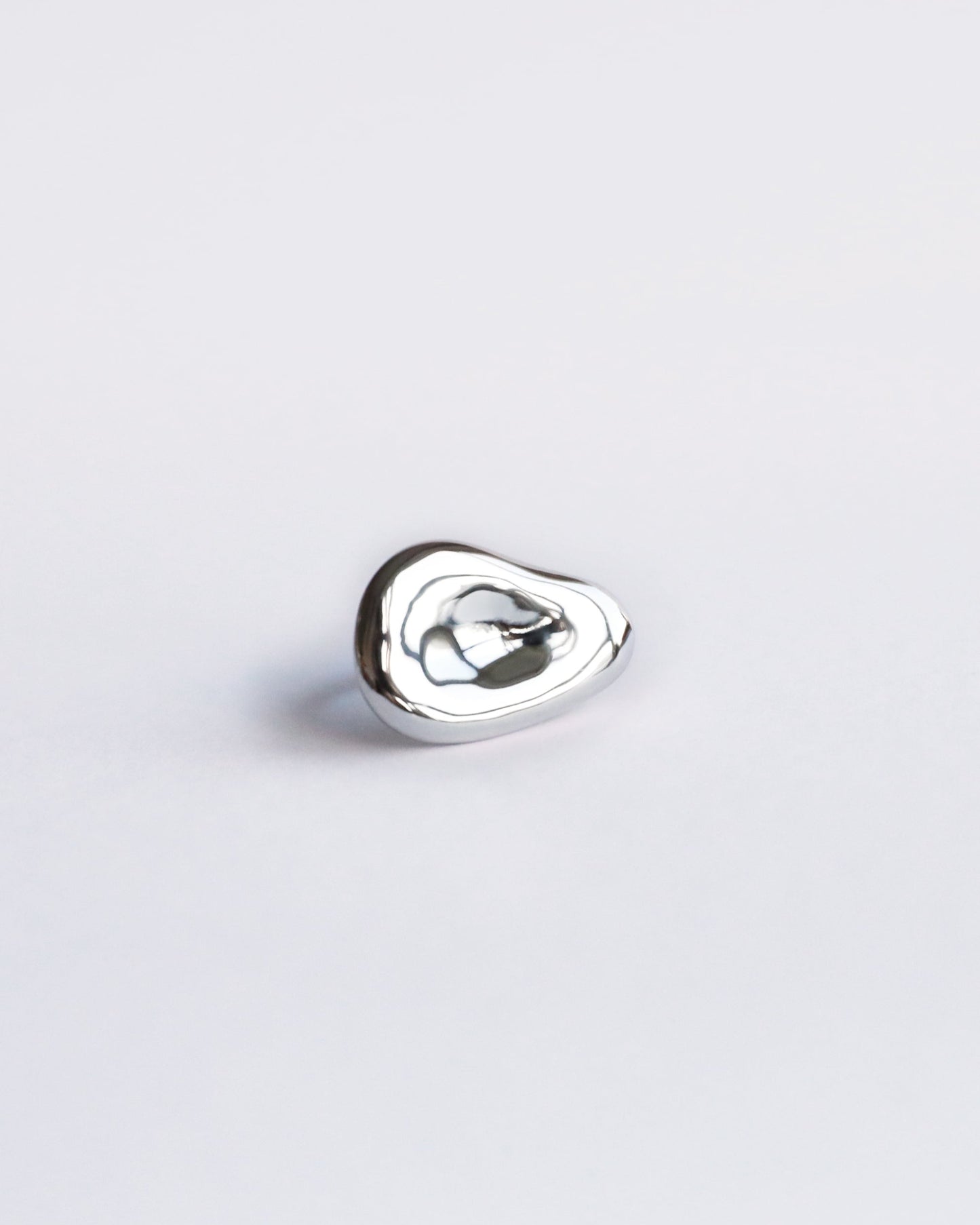 Centered product image of polished sterling silver sculptural ring with organic shape