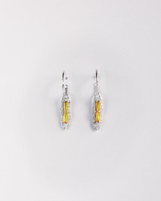 Front view of yellow zircon sterling silver drop earrings on white background