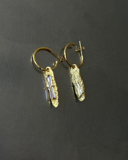 Back view of gold plated sterling silver earrings with white zircon and S925 engraving on dark background
