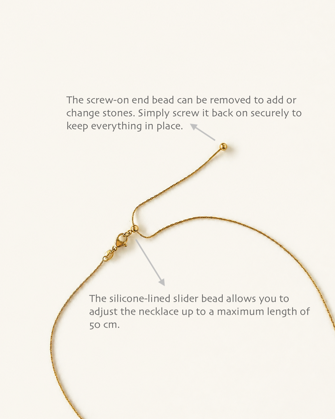 Instructional diagram showing a gold necklace with text callouts explaining how to remove the screw-on end bead and how the silicone-lined slider bead allows length adjustment, on a light cream background.