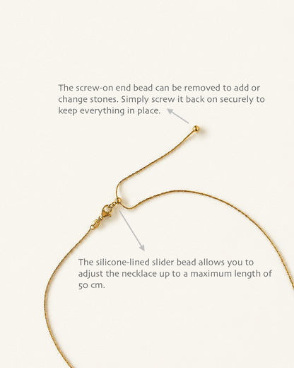 Instructional diagram showing a gold necklace with text callouts explaining how to remove the screw-on end bead and how the silicone-lined slider bead allows length adjustment, on a light cream background.
