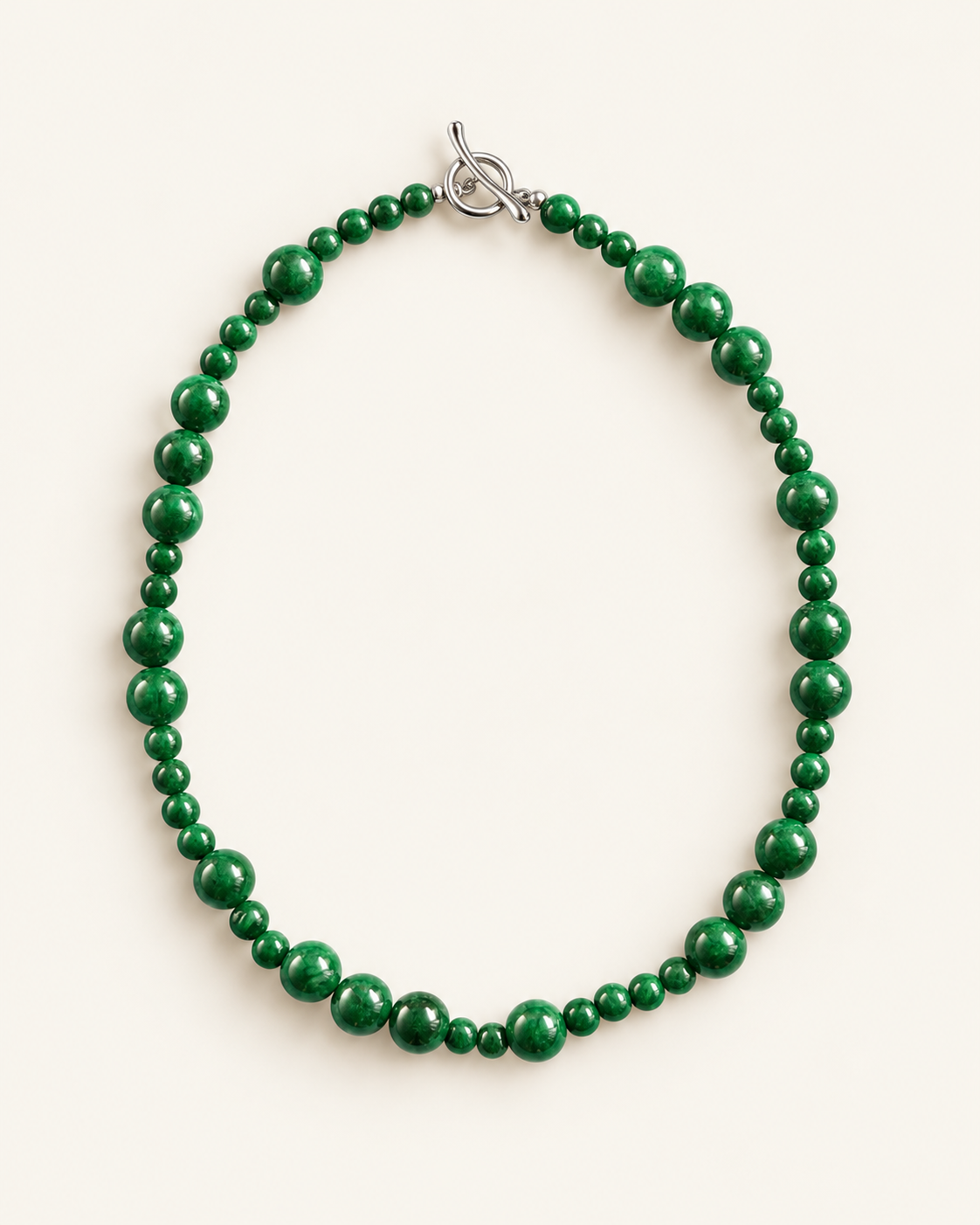 Handcrafted green chalcedony beaded necklace with natural stone beads and silver toggle clasp, photographed on a cream background.
