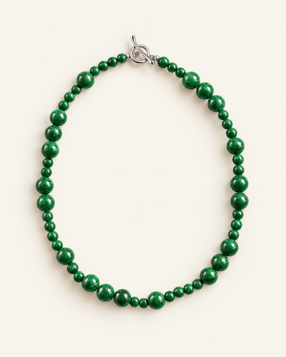 Handcrafted green chalcedony beaded necklace with natural stone beads and silver toggle clasp, photographed on a cream background.
