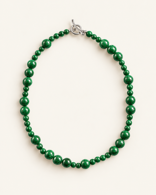 Handcrafted green chalcedony beaded necklace with natural stone beads and silver toggle clasp, photographed on a cream background.
