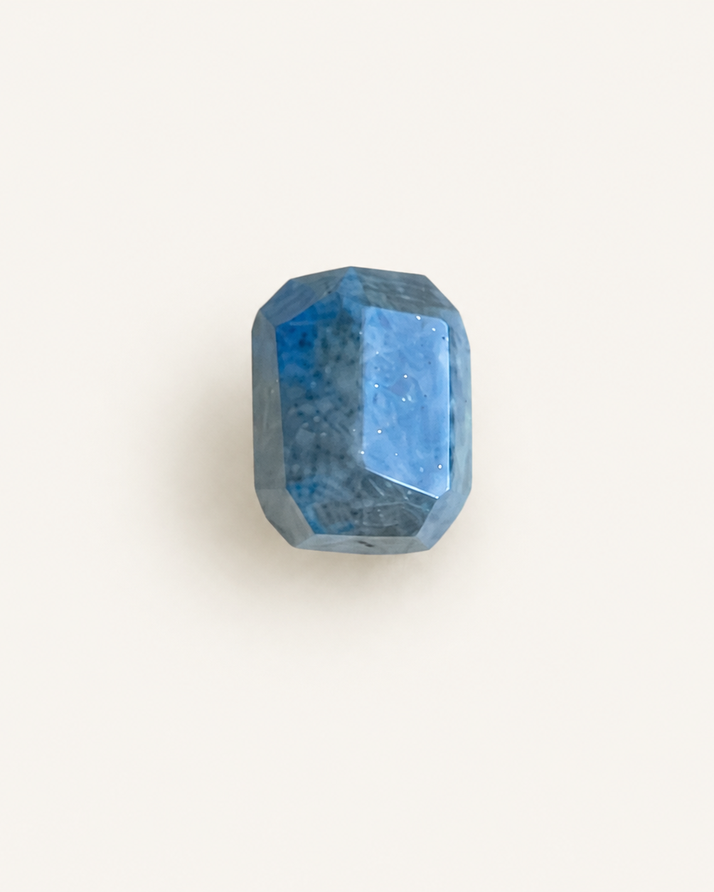 Faceted step-cut lapis lazuli with gold pyrite flecks and white calcite veining