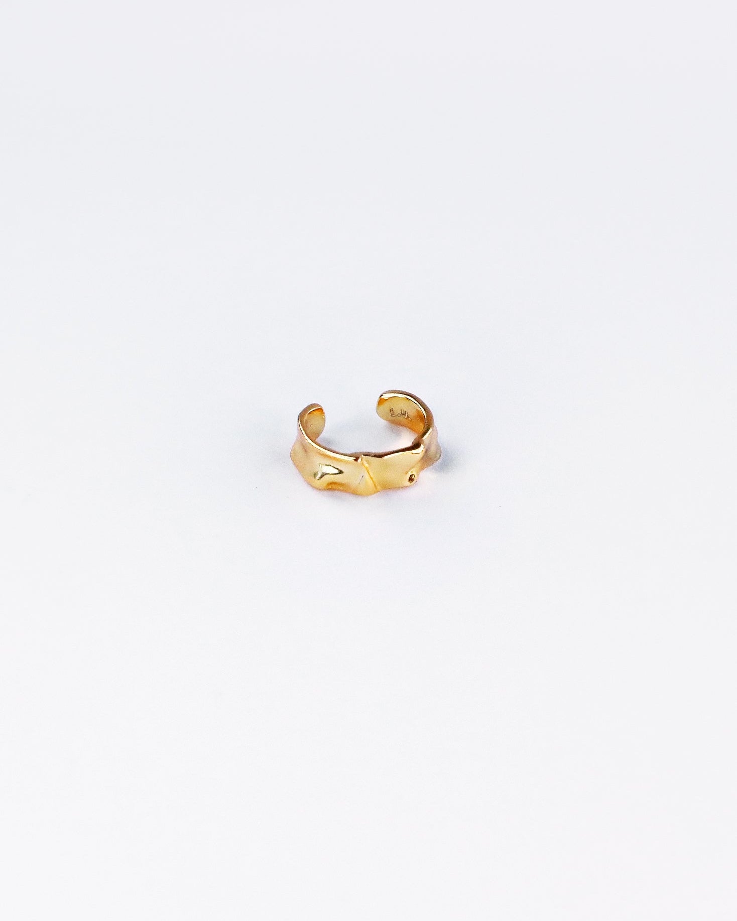 18K gold plated sterling silver ear cuff on white background, showcasing wavy textured surface