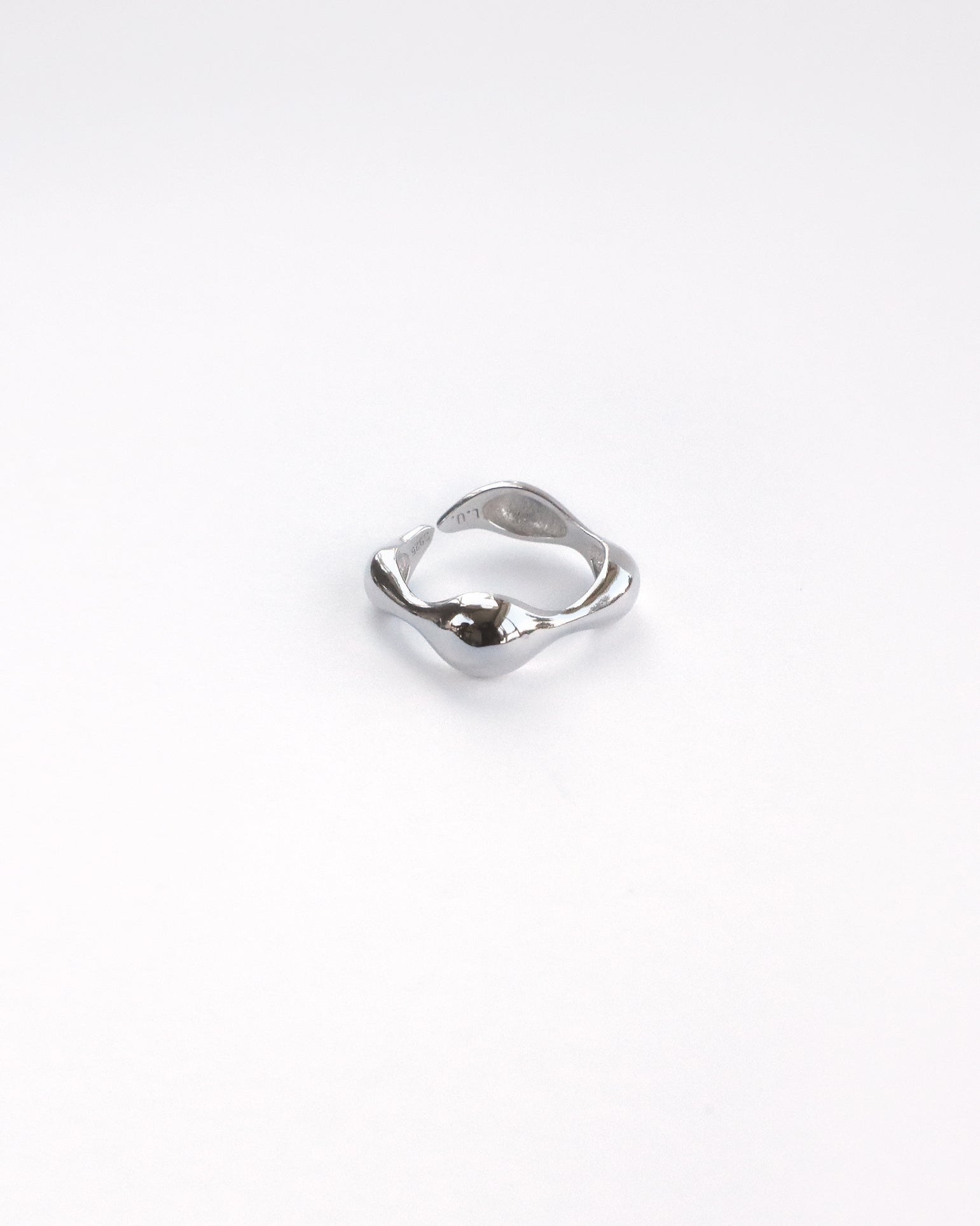 Close-up of polished sterling silver ring with sculptural organic shape – thick version