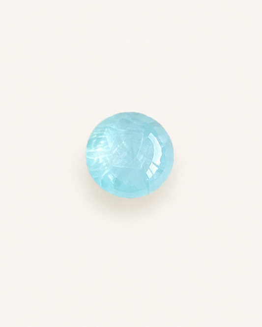 Pale blue aquamarine cabochon with a smooth domed surface