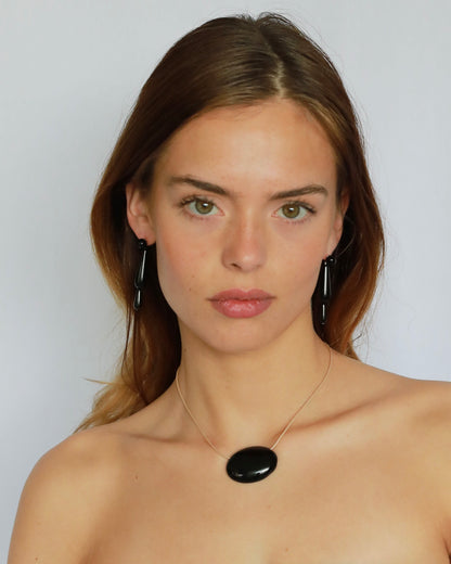 Super long adjustable necklace with polished natural black onyx pendant on soft beige cord. Minimal modern natural stone jewelry.