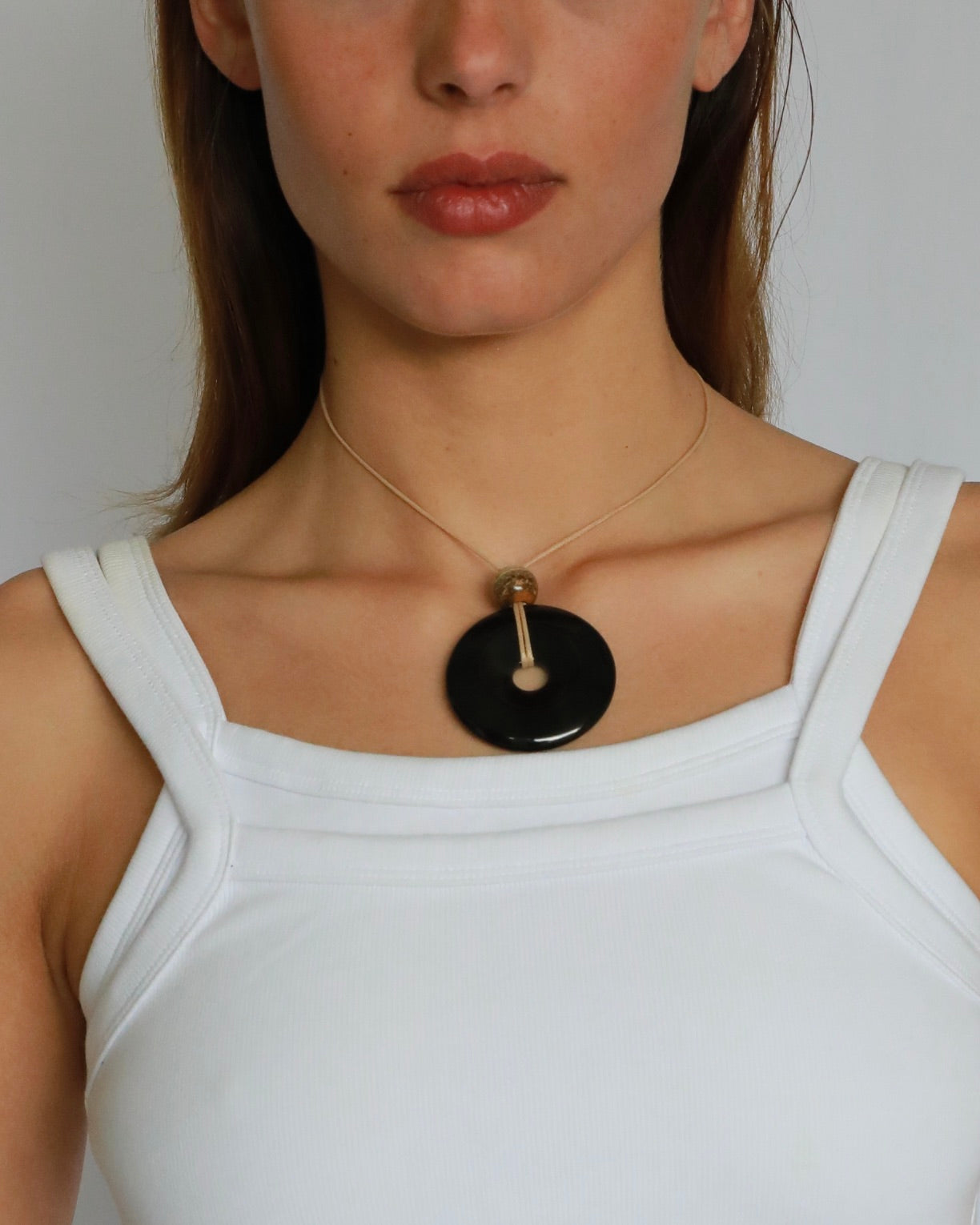 Super long adjustable necklace with polished black onyx pendant, natural picture jasper bead, and beige wax rope cord.