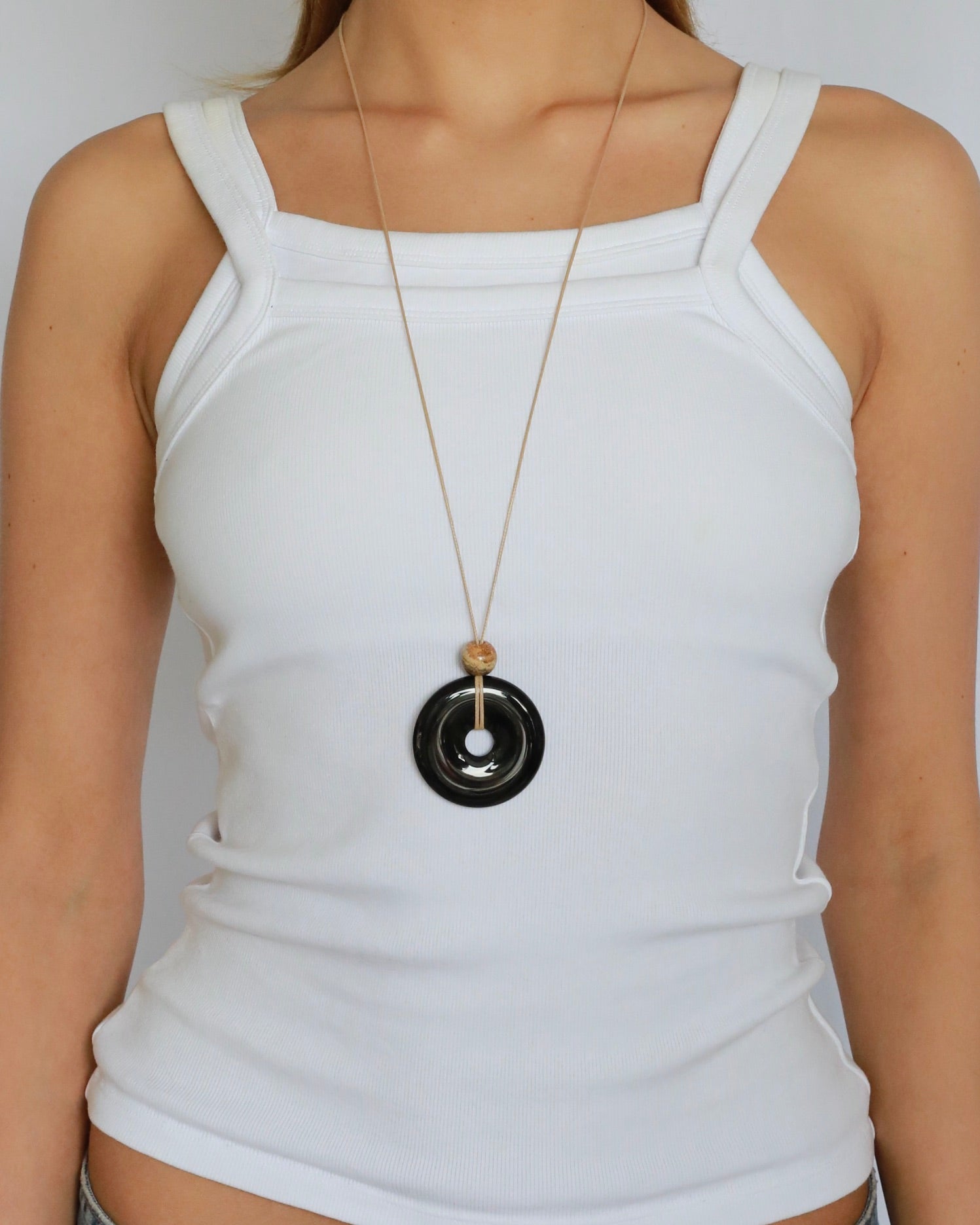 Super long adjustable necklace with polished black onyx pendant, natural picture jasper bead, and beige wax rope cord.