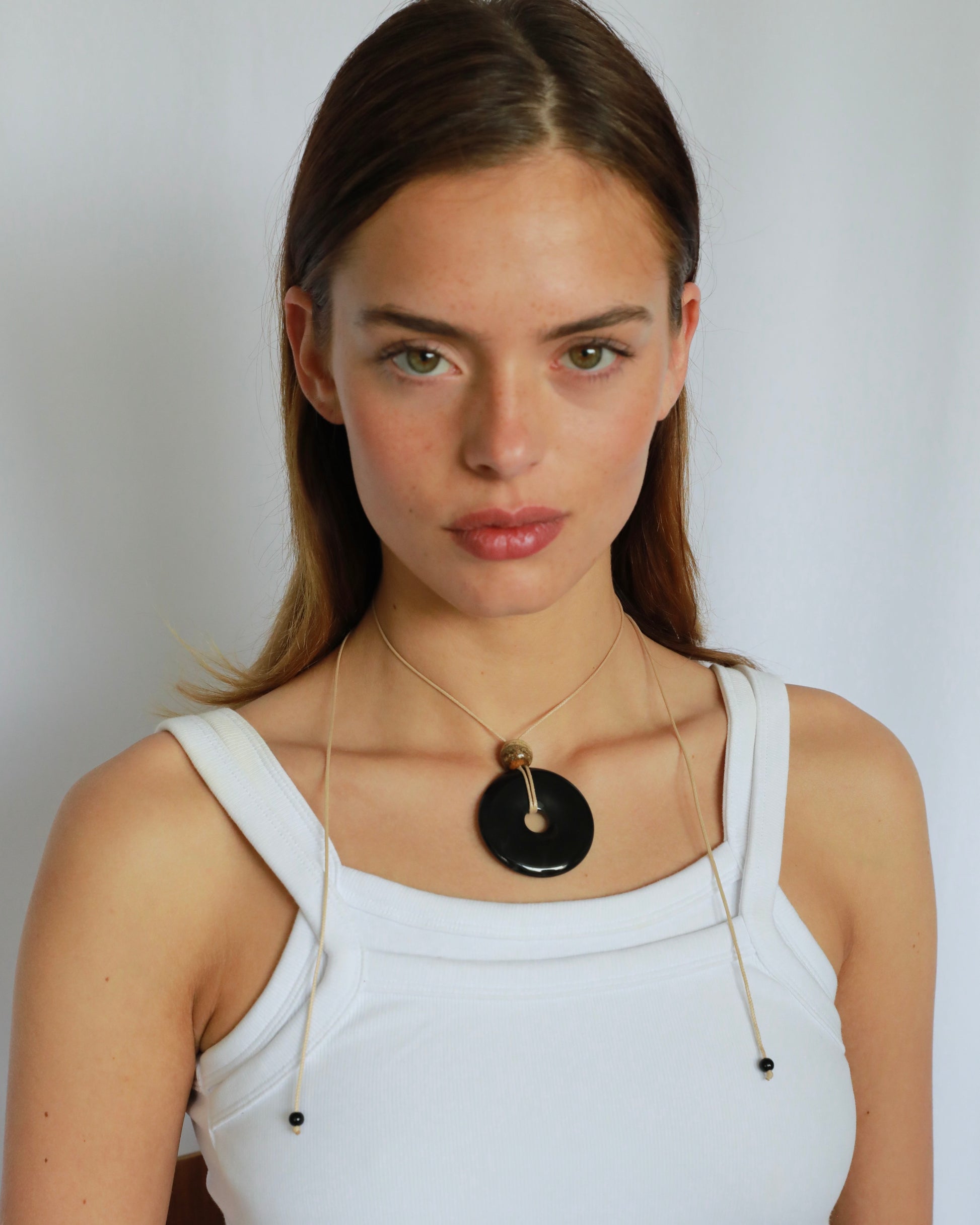 Super long adjustable necklace with polished black onyx pendant, natural picture jasper bead, and beige wax rope cord.