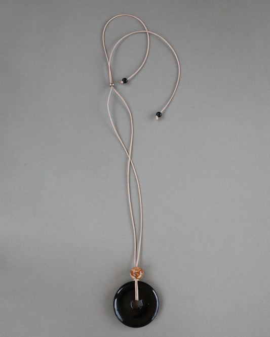 Super long adjustable necklace with polished black onyx pendant, natural picture jasper bead, and beige wax rope cord.