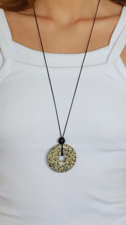 Super long dalmatian jasper pendant necklace with natural black and white spotted stone on adjustable black wax rope cord.