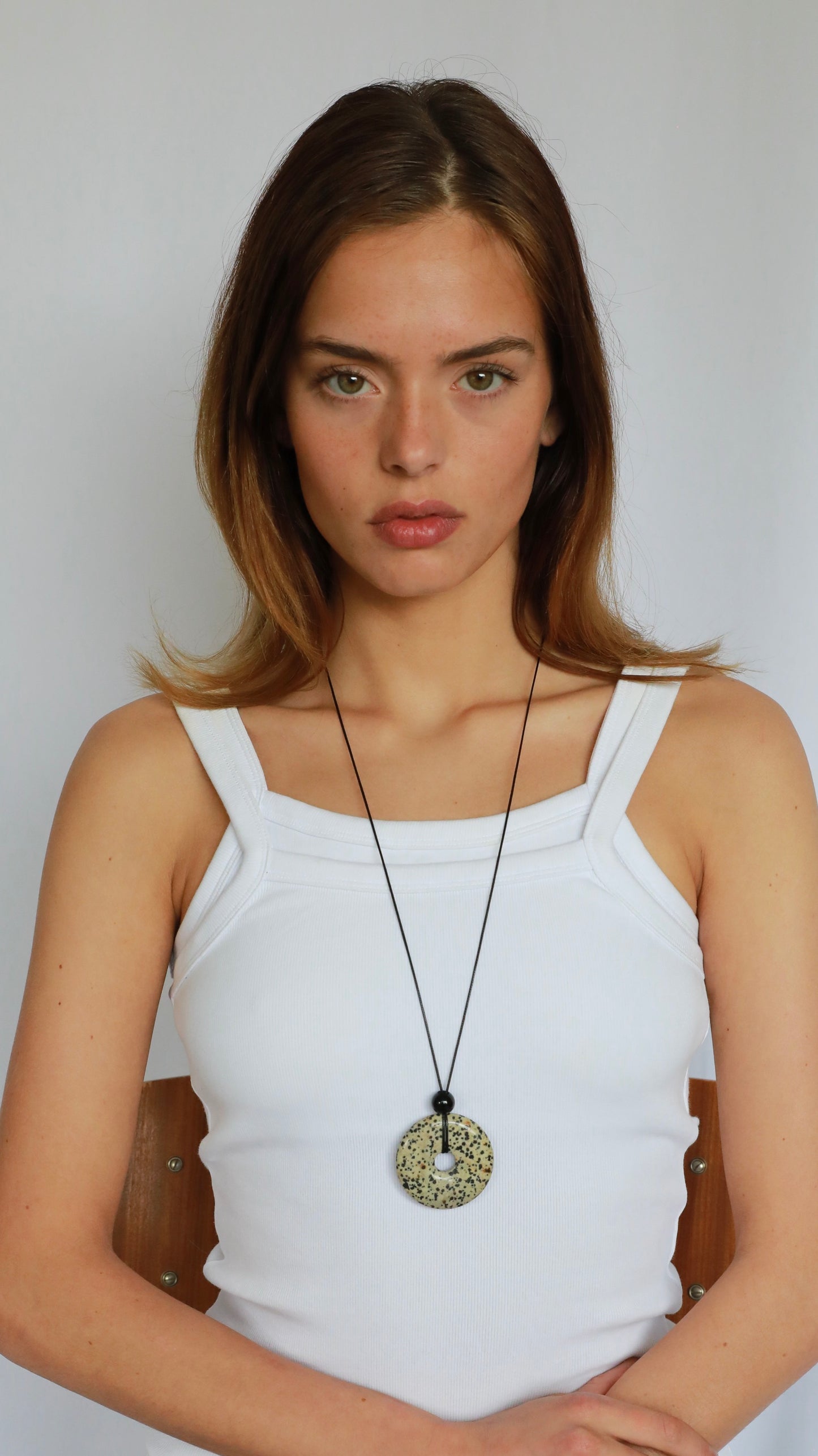 Super long dalmatian jasper pendant necklace with natural black and white spotted stone on adjustable black wax rope cord.