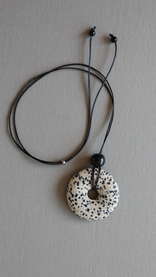 Super long dalmatian jasper pendant necklace with natural black and white spotted stone on adjustable black wax rope cord.