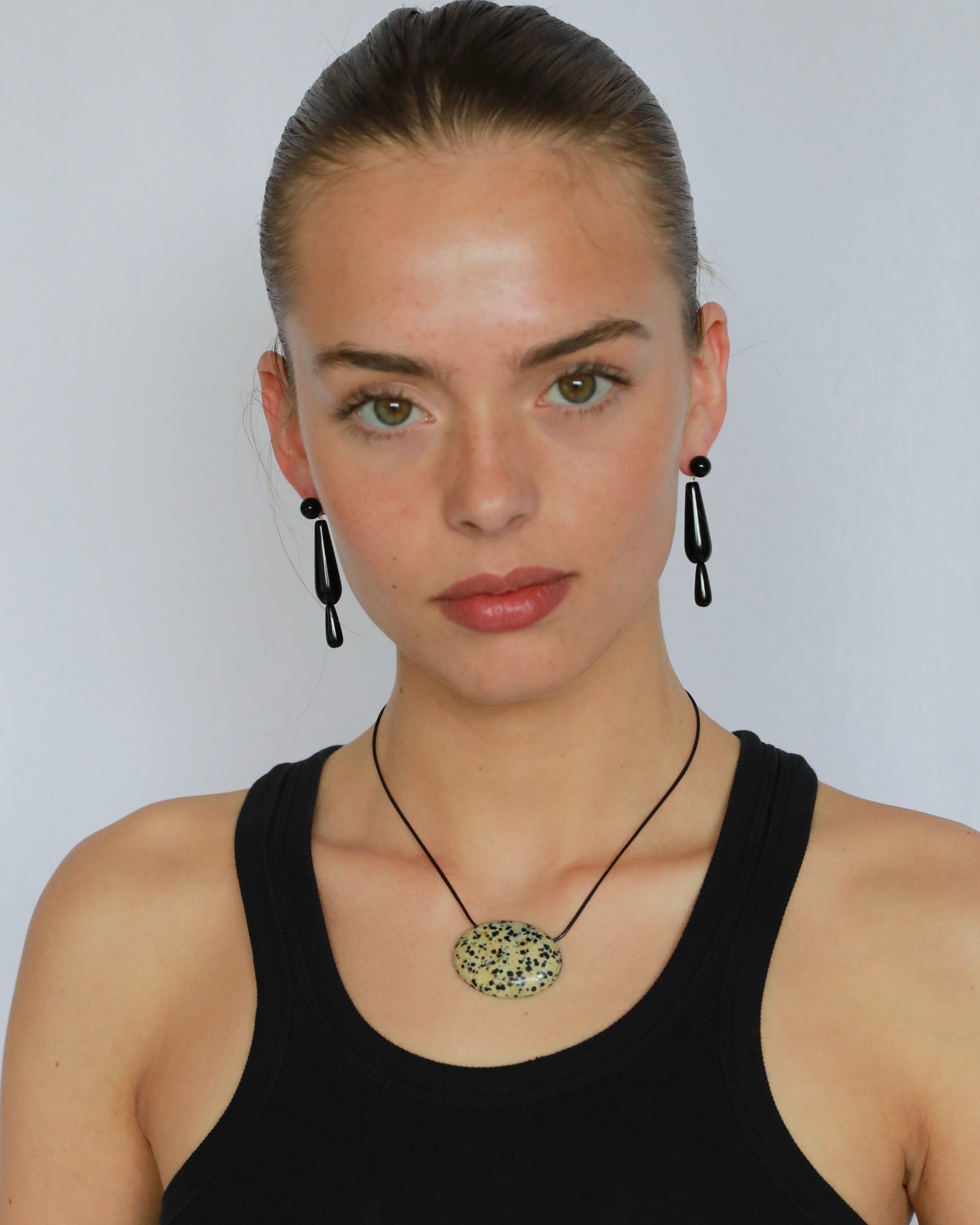 Super long dalmatian jasper pendant necklace with natural black and white spotted stone on adjustable black wax rope cord