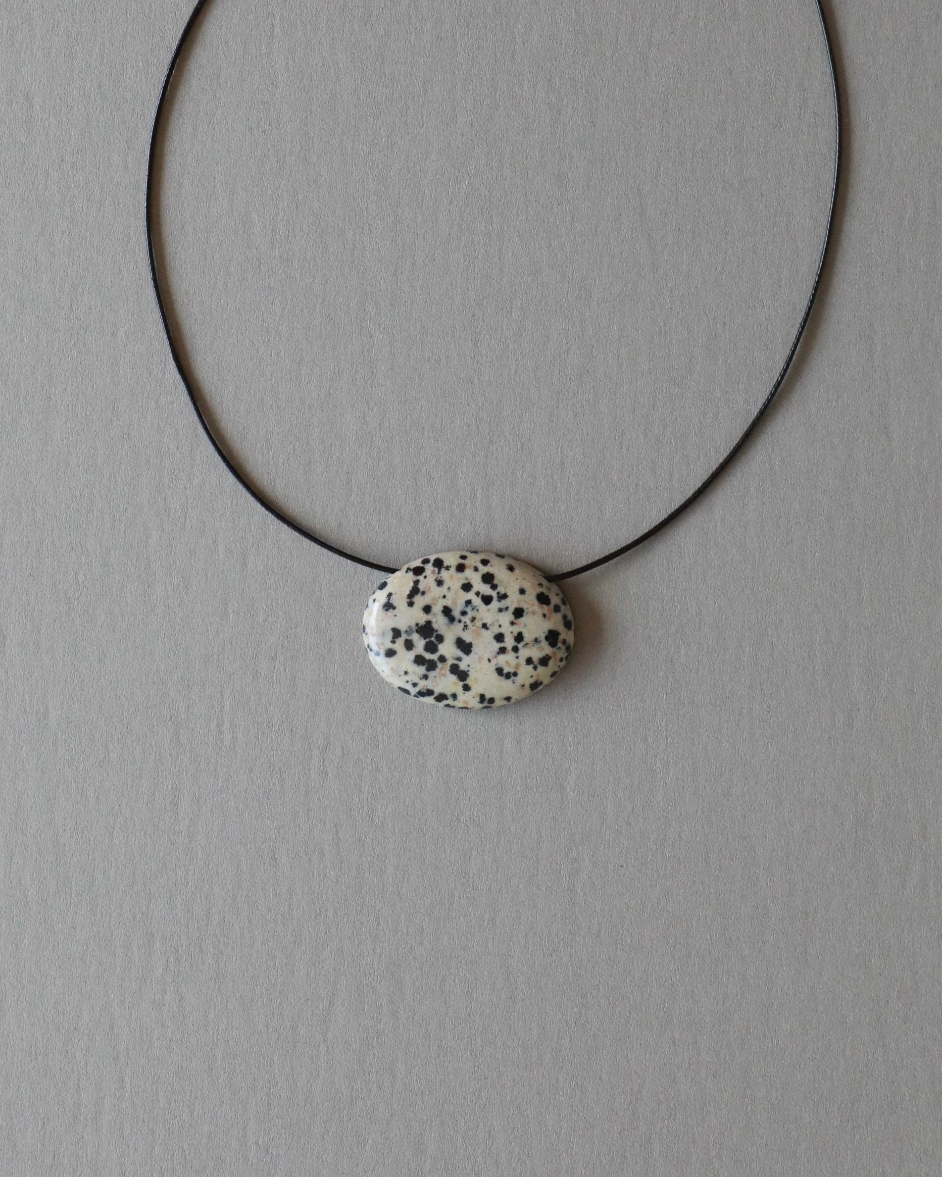 Super long dalmatian jasper pendant necklace with natural black and white spotted stone on adjustable black wax rope cord