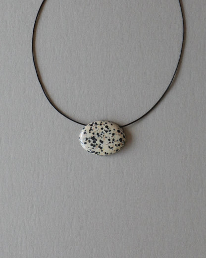 Super long dalmatian jasper pendant necklace with natural black and white spotted stone on adjustable black wax rope cord