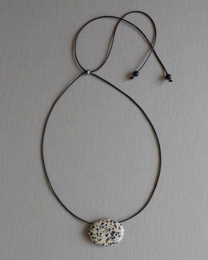 Super long dalmatian jasper pendant necklace with natural black and white spotted stone on adjustable black wax rope cord