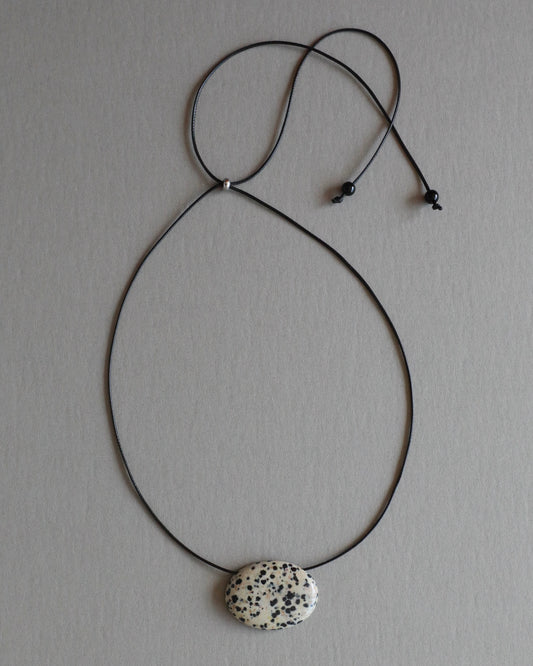 Super long dalmatian jasper pendant necklace with natural black and white spotted stone on adjustable black wax rope cord