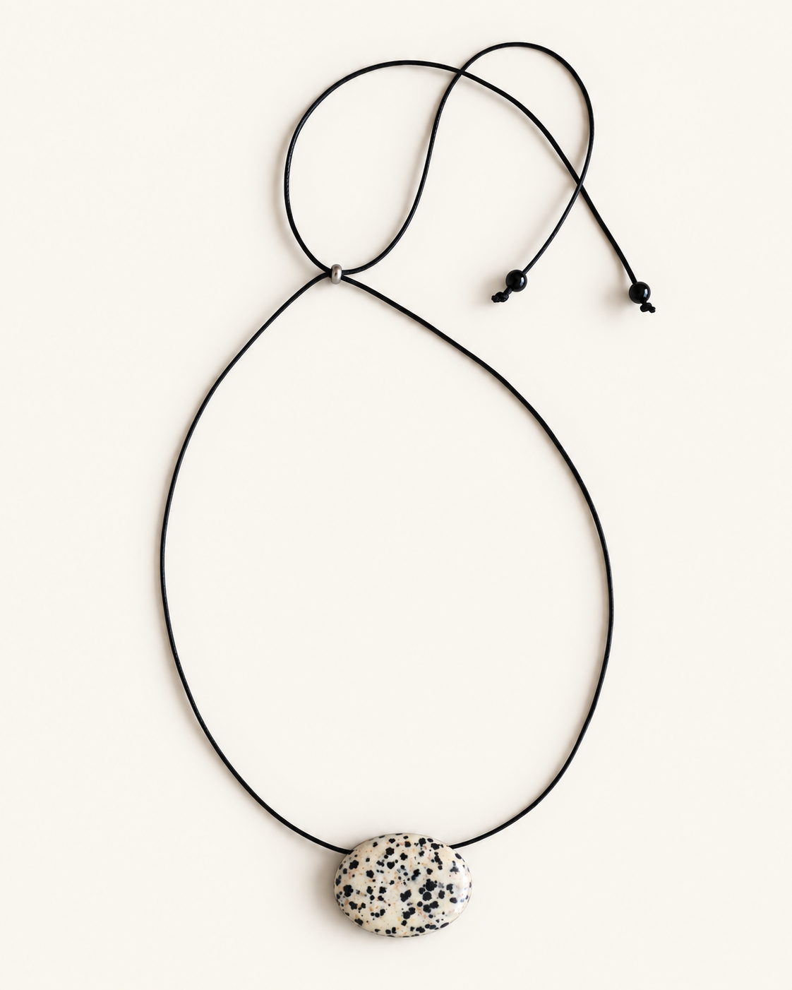 Super long dalmatian jasper pendant necklace with natural black and white spotted stone on adjustable black wax rope cord