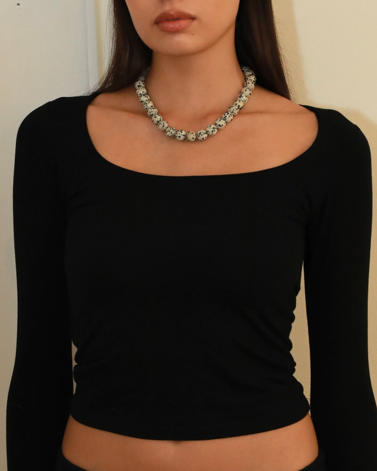 Chunky Dalmatian stone bead necklace with adjustable silver clasp in Nordic minimalist style product photo on model