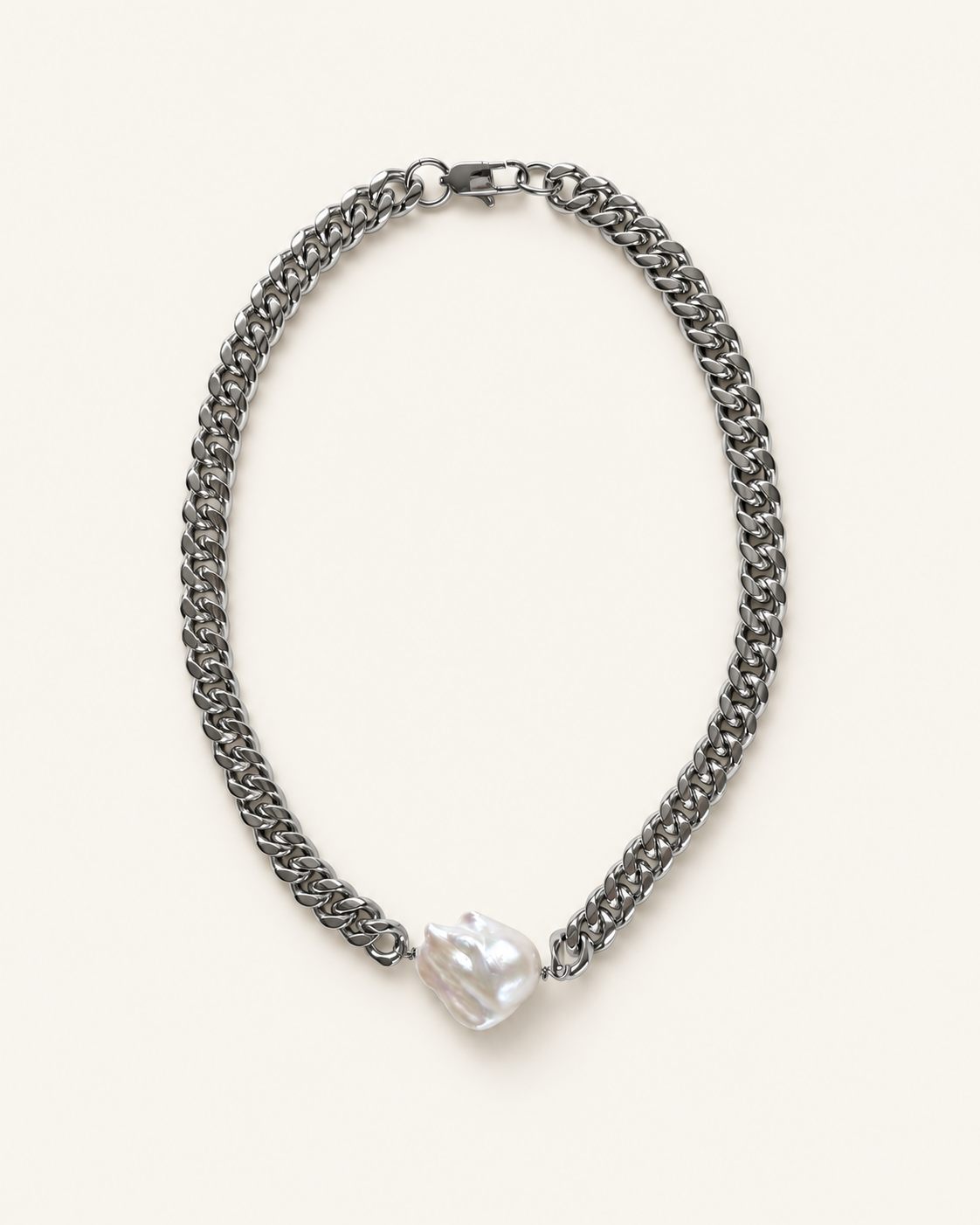 A stainless chain necklace with a single irregular, lustrous white pearl pendant, displayed on a clean off-white background.