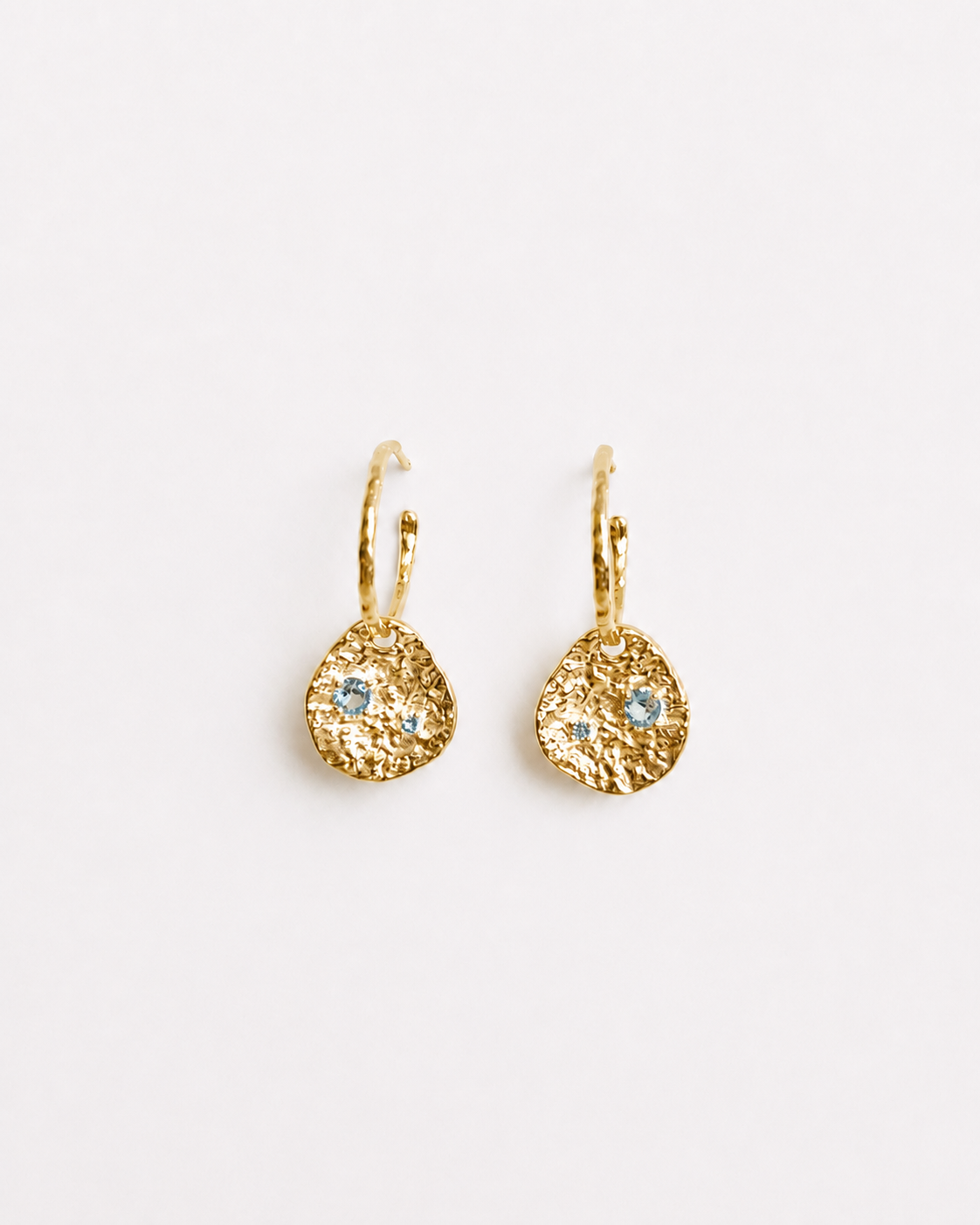 Gold coin drop earrings with hammered 18K gold-plated brass pendants and two round lab-grown aquamarine-blue spinel stones 