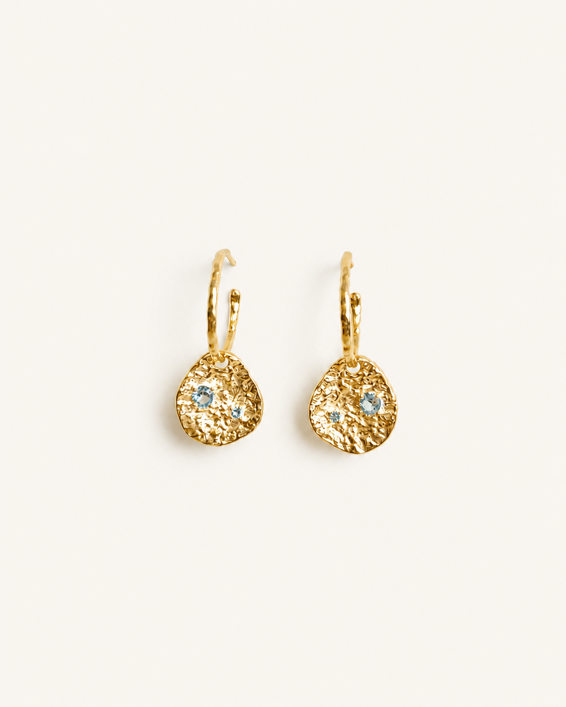 Gold coin drop earrings with hammered 18K gold-plated brass pendants and two round lab-grown aquamarine-blue spinel stones 
