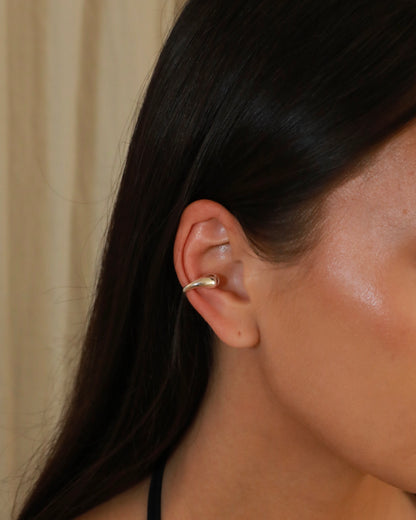 Polished sterling silver ear cuff with an open sculptural design and rounded ends model