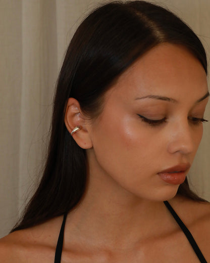 Polished sterling silver ear cuff with an open sculptural design and rounded ends