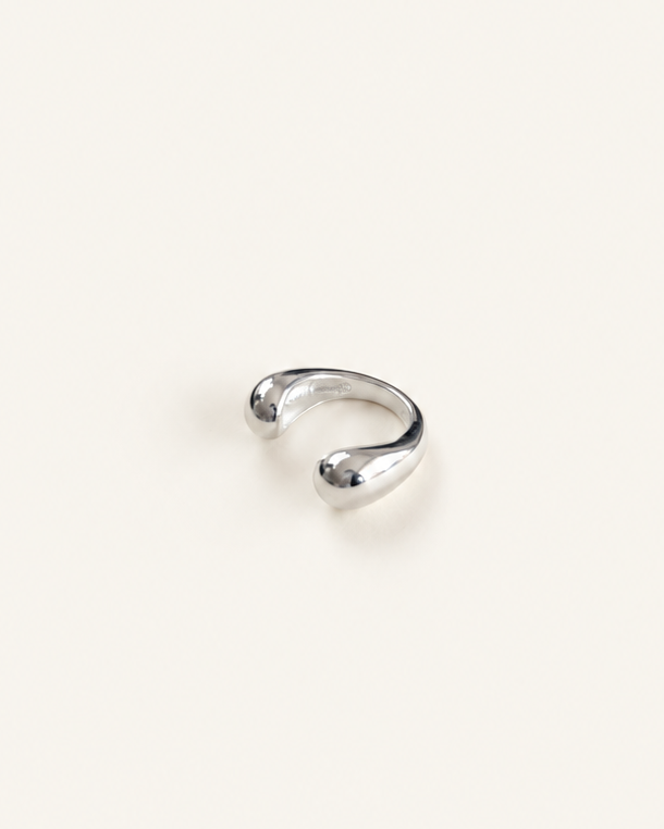 Polished sterling silver ear cuff with an open sculptural design and rounded ends