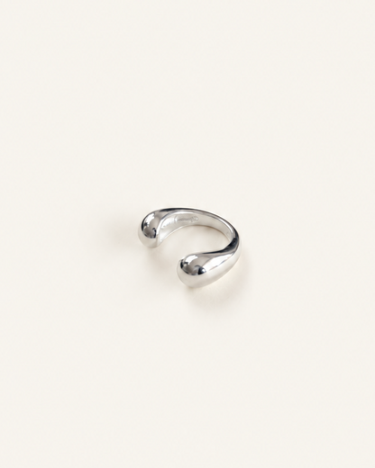 Polished sterling silver ear cuff with an open sculptural design and rounded ends