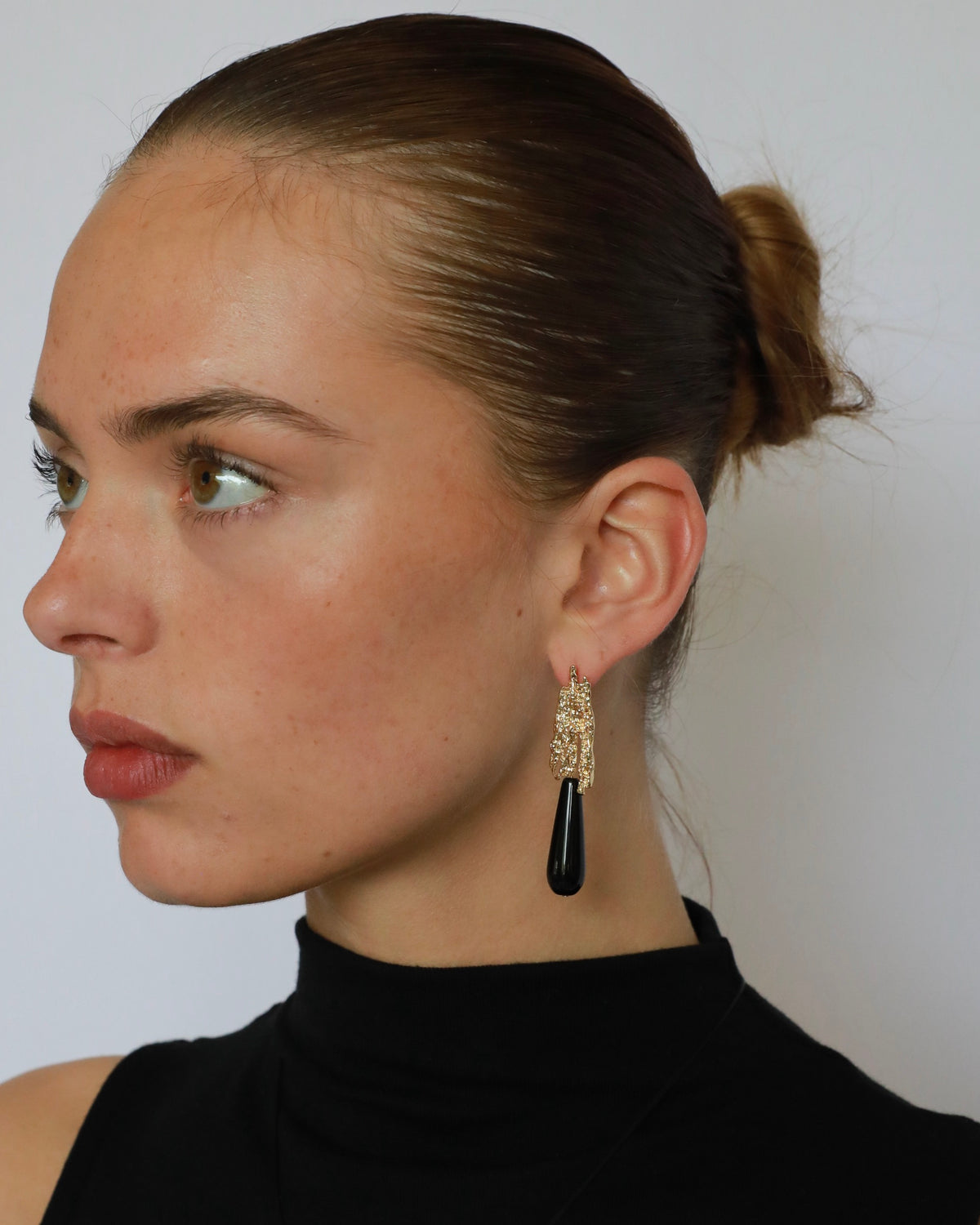 Natural black onyx teardrop earrings with textured gold-plated brass