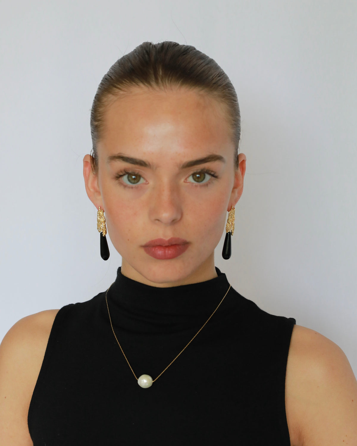 Natural black onyx teardrop earrings with textured gold-plated brass