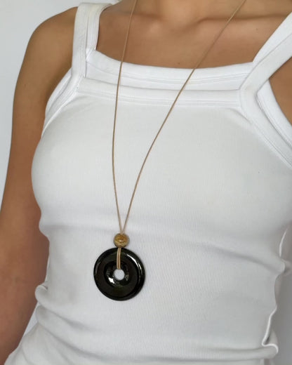 Super long adjustable necklace with polished black onyx pendant, natural picture jasper bead, and beige wax rope cord.