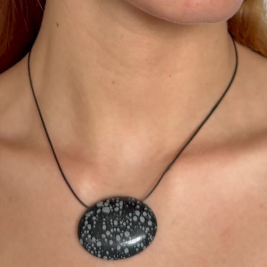 Super long snowflake obsidian pendant necklace with natural black and white speckled stone on adjustable black wax rope cord