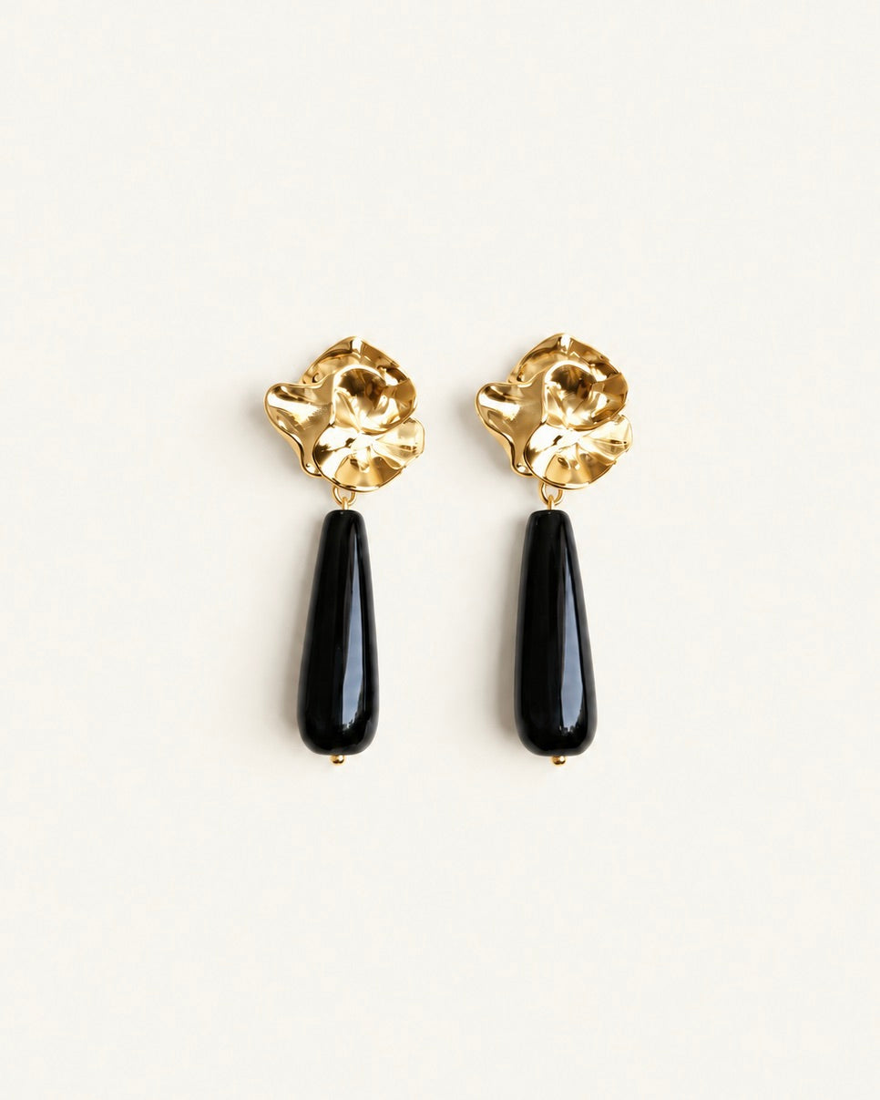 Gold-tone sculptural flower drop earrings with long polished black onyx stones