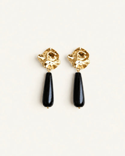 Gold-tone sculptural flower drop earrings with long polished black onyx stones