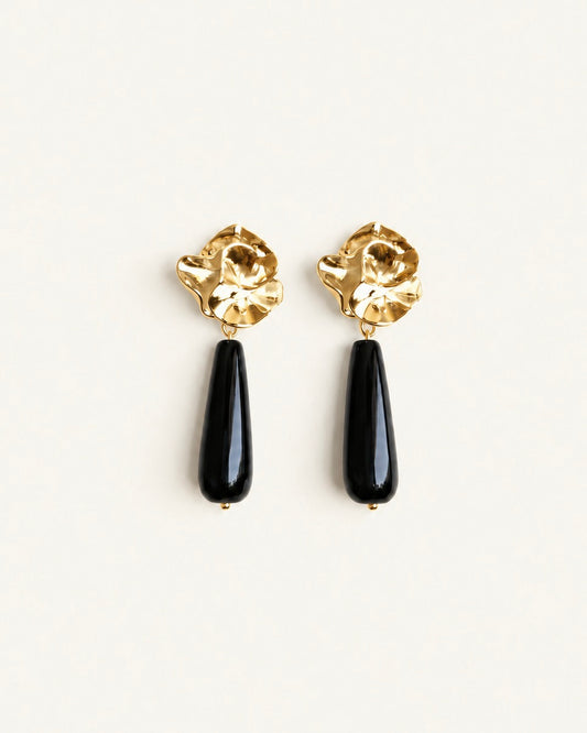 Gold-tone sculptural flower drop earrings with long polished black onyx stones