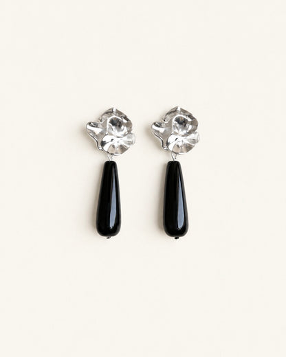 Silver-tone sculptural flower drop earrings with long polished black onyx stones