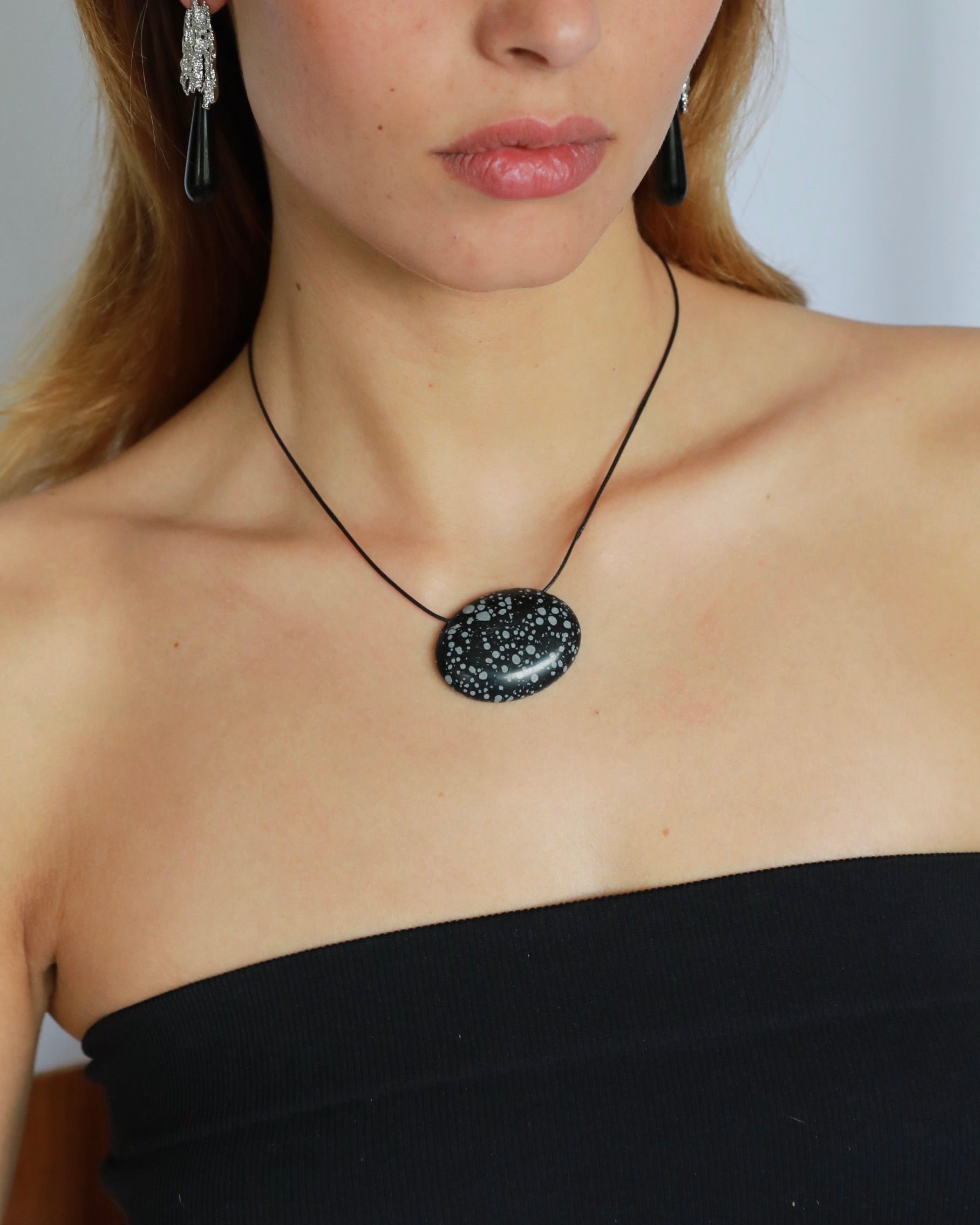 Super long snowflake obsidian pendant necklace with natural black and white speckled stone on adjustable black wax rope cord