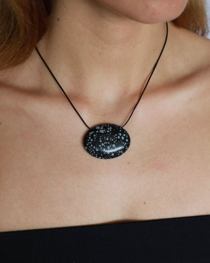 Super long snowflake obsidian pendant necklace with natural black and white speckled stone on adjustable black wax rope cord