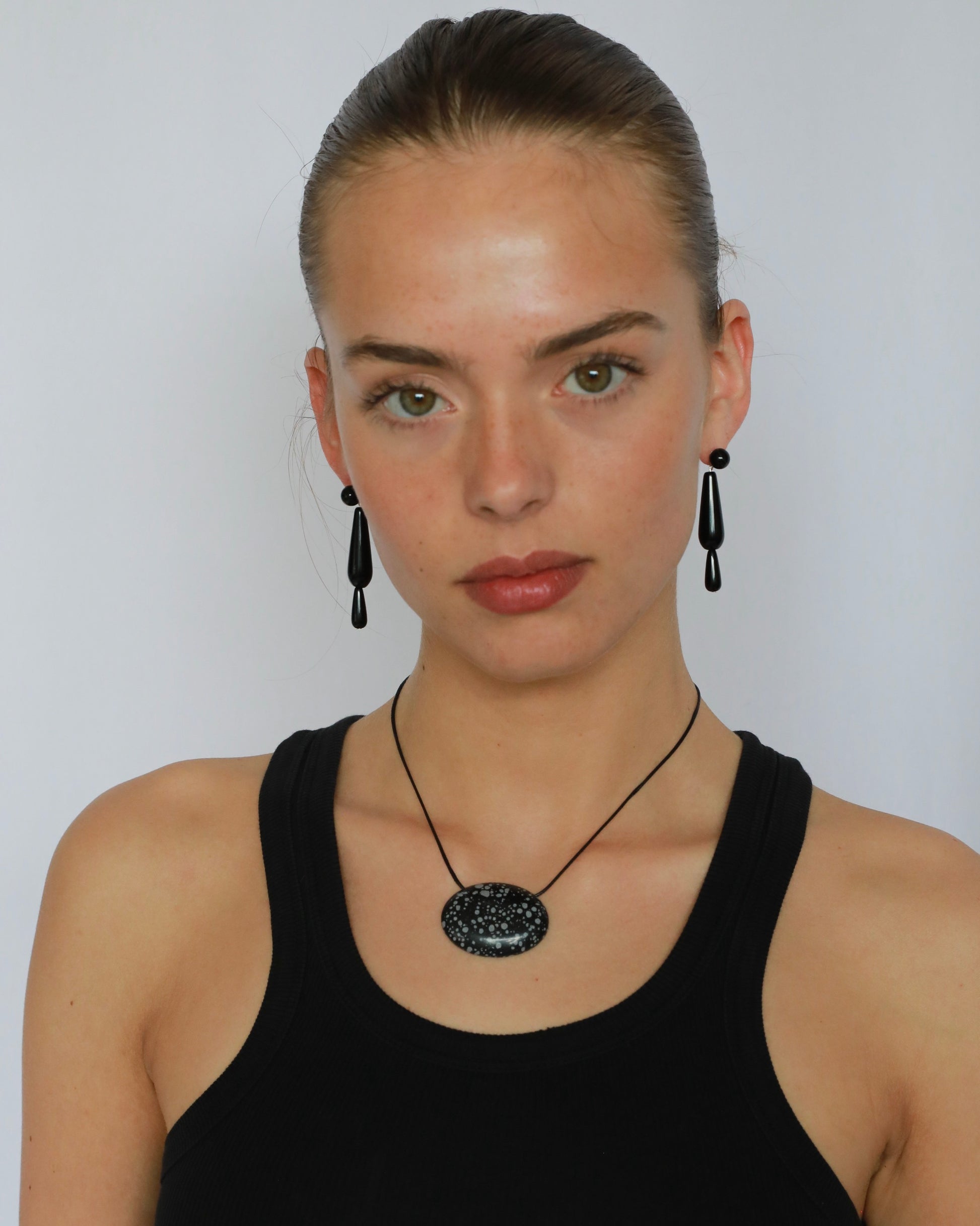 Super long snowflake obsidian pendant necklace with natural black and white speckled stone on adjustable black wax rope cord